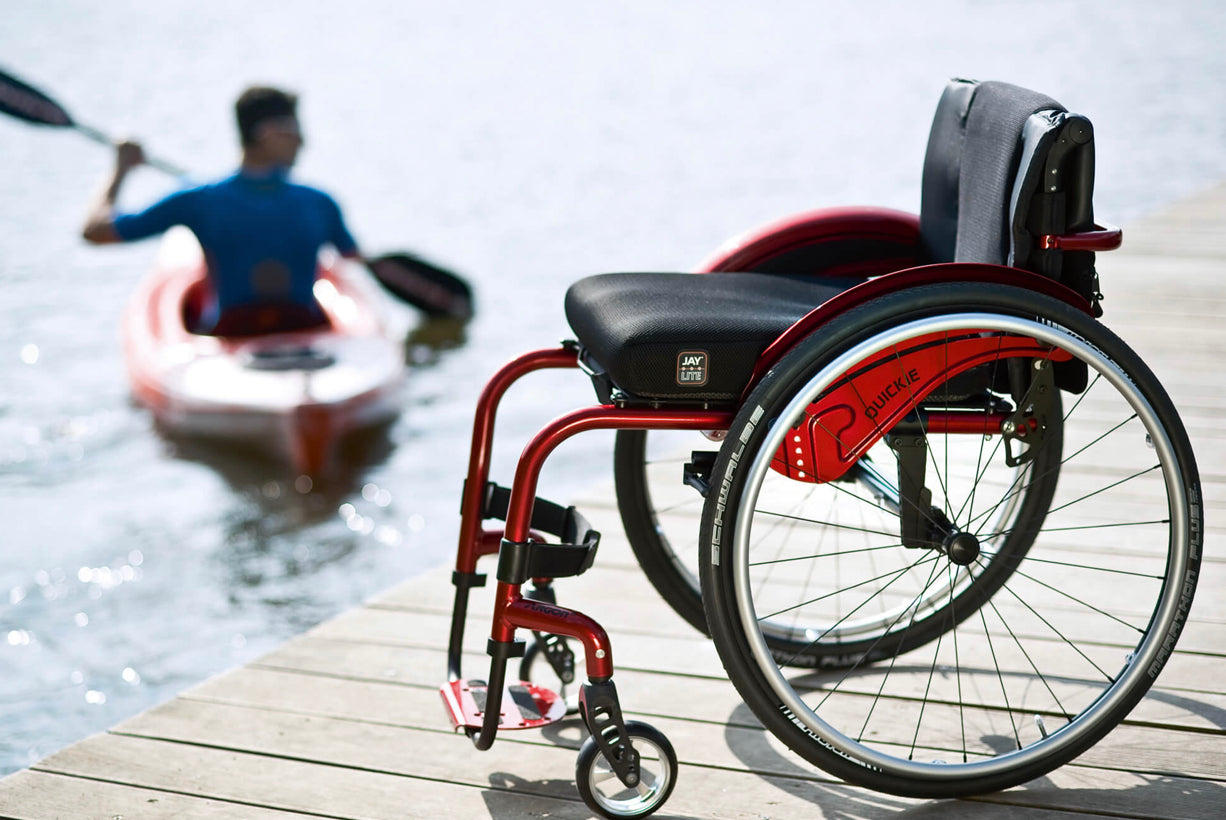 Motus - Quickie Argon 2 manual wheelchair in Red on Lake boardwalk